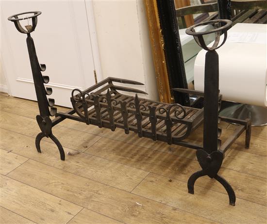 A wrought iron fire basket and a pair of fire dogs basket overall width 105cm